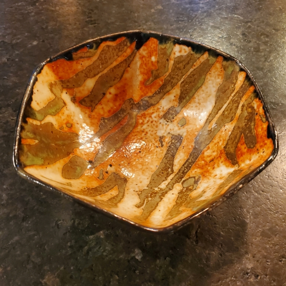 Handmade tiger stripe ceramic bowl signed by artist orange, cream and black